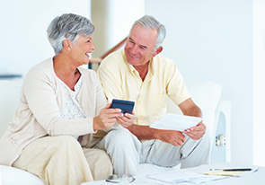 A couple gathering their finances for planned giving. Links to Gifts of Life Insurance