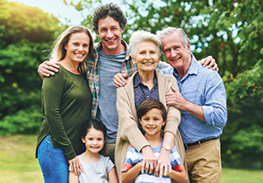 A mulit-generational family smiling. Links to Donor-Advised Funds