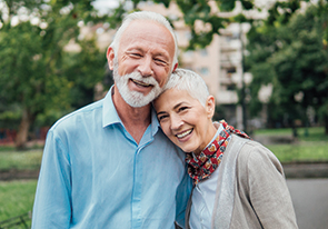 A couple smiling. Links to Gifts That Pay You Income