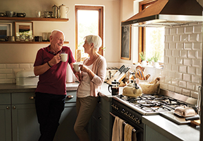 A couple drinking coffee. Links to Gifts from Retirement Plans